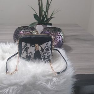 Small black pocketbook with black and white bow